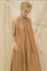 Sleeveless gathered organza dress with relaxed A-line silhouette and tie shoulder detailing